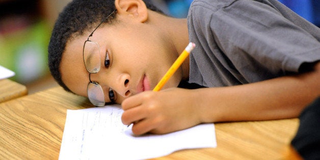 Jelani Guzman, a fifth-grader at Silver Lake Elementary School in Middletown, Del., works on an English language arts lesson at school Tuesday, Oct. 1, 2013. Silver Lake has begun implementing the national Common Core State Standards for academics. Remembering the plot of a short story is no longer good enough. Now, students are being asked to think more critically -- what, for example, might a character say in an email to a friend. Welcome to a classroom using the Common Core State Standards, one of the most politicized and misunderstood changes in education for students and their teachers in grades kindergarten through high school. (AP Photo/Steve Ruark)