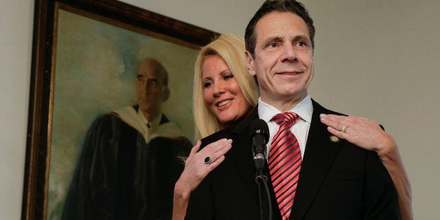 New York Gov. Andrew Cuomo speaks to members of the media as his partner, Sandra Lee looks on after casting his ballot Tuesday, Nov. 4, 2014, in Mount Kisco, N.Y. A victory by Cuomo over Republican challenger Rob Astorino on Tuesday would make him the first Democratic governor since his father, Mario Cuomo, to win re-election in the nation's third-largest state. (AP Photo/Julie Jacobson)