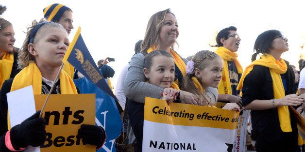 DENVER, CO - JANUARY 26: Molly McCoy, 10, left, and her other fifth-grade classmates Sidney Welch, 11, second from left, Lily Gillespie, 11, second from right, and Sidney's mom Randi, top center, from the SkyView Academy in Highlands Ranch, join the crowds at the Capitol. School choice supporters, parents, and teachers gather on the west steps of the State Capitol in Denver in support of National School Choice Week 2015 on Monday, Jan. 26, 2015. The independent public awareness education campaign plans to feature 11,082 independently-planned special events across all 50 states. (Photo by Kathryn Scott Osler/The Denver Post via Getty Images)