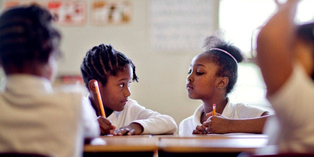 In this Thursday, April 18, photo, Burgess-Peterson Elementary School first graders Jacqueline Wright, left, and Kennedy Thomas, work through a lesson as part of Atlanta Public School's after-school remediation program in Atlanta. Anxiety is high among students and teachers with state standardized tests set to begin Tuesday. A lot of focus and criticism has been aimed at the tests, known as CRCT in Georgia, since one of the nation's largest cheating scandals erupted within the Atlanta Public Schools system a few years back that included allegations that teachers and principals changed scores to inflate performance. While criminal charges are pending against 35 former Atlanta educators, the district has been working on a system-wide remediation program aimed at helping those directly affected by the cheating scandal and others who have simply fallen behind. (AP Photo/David Goldman)