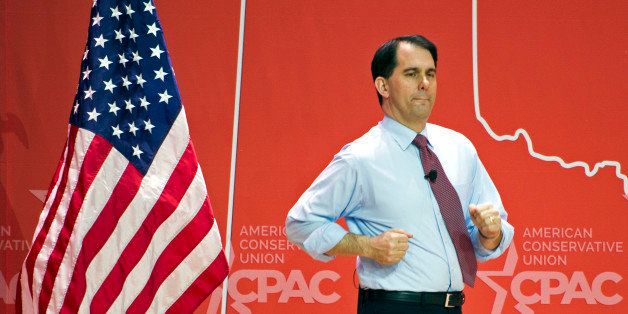 Wisconsin Gov. Scott Walker runs onstage to address the Conservative Political Action Conference (CPAC) in National Harbor, Md., Thursday, Feb. 26, 2015. (AP Photo/Cliff Owen)