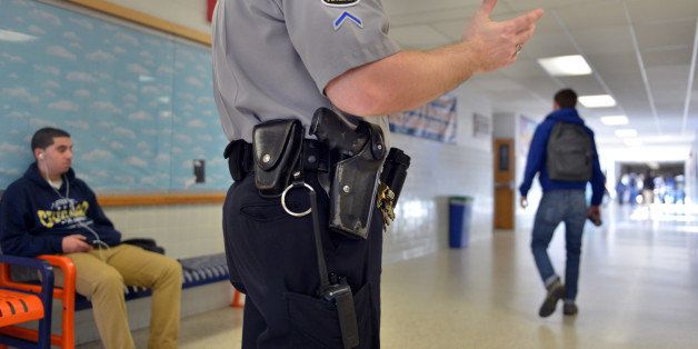 SPRINGFIELD, VA - JANUARY 18:Officer Joe Plazio, of the Fairfax County Police Department, stays armed with his service pistol as he patrols the hallways where he is stationed at West Springfield High School on Friday, January 18, 2012, in Springfield, VA. Fairfax County has taken a variety of approaches to making schools safe. Each of the high schools and middle schools have a Fairfax County school resource officer, who is an armed sworn officer with the Fairfax County Police.(Photo by Jahi Chikwendiu/The Washington Post via Getty Images)