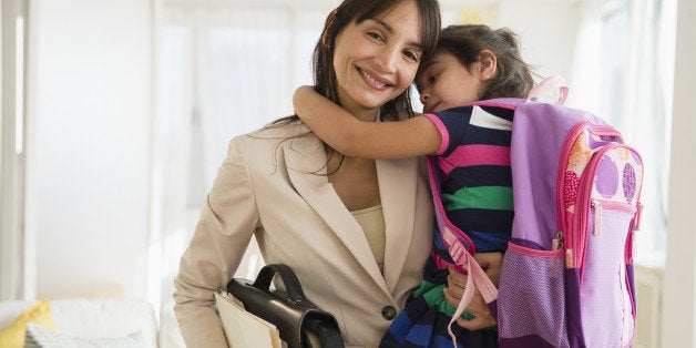 Hispanic daughter hugging mother as she leaves for work