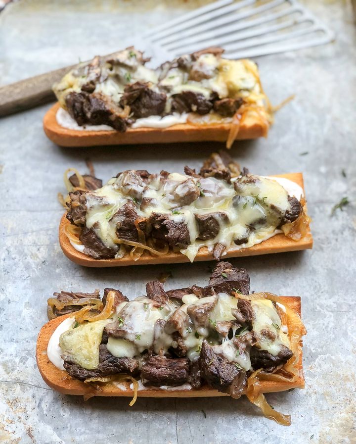 Toasted baguettes slathered in horseradish mayo, topped with roast beef, caramelized onions and cheese (in this case, raclette).