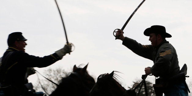 Confederate and Union forces clash during a re-enactment of the Battle of Appomattox Station, Wednesday, April 8, 2015, as part of the 150th anniversary of the surrender of the Army of Northern Virginia to Union forces at Appomattox Court House, in Appomattox, Va. (AP Photo/Steve Helber)