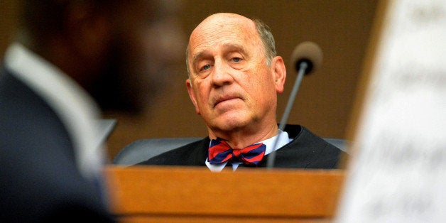 Fulton County Superior Court Judge Jerry Baxter listens as former Dunbar Elementary School testing coordinator Lera Middlebrooks testifies under cross examination by defense attorney Keith Adams, about cheating at Dunbar for a second day during the Atlanta Public Schools test-cheating trial in Fulton County Superior Court in Atlanta, Thursday, Dec. 4, 2014. Three former Dunbar teachers are among 12 educators and administrators who prosecutors say cheated, lied and stole as part of a widespread but cleverly disguised conspiracy to inflate state test scores that affected thousands of students. Middlebrooks pleaded guilty to obstruction charges and was sentenced to 12 months probation and 250 hours of community service in December 2013. (AP Photo/Atlanta Journal-Constitution, Kent D. Johnson, Pool)