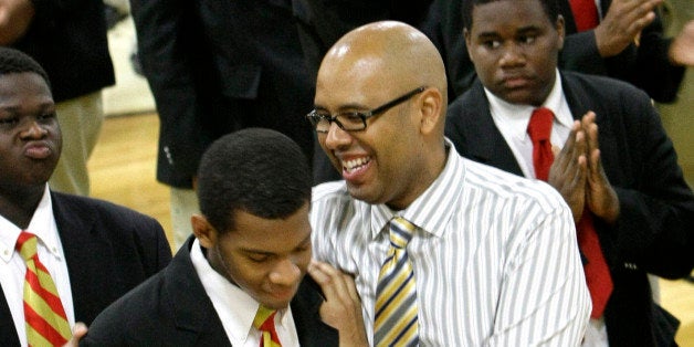 **ADVANCE FOR MONDAY JUNE 28** In this photo taken Tuesday, June 1, 2010 Urban Prep High School founder Tim King, right, embraces a senior at the all male high school during a morning assembly time called "Community". in Chicago. "I wanted to create a school that was going to put black boys in a different place," he says, "and in my mind, that different place needed to be college." Now King has seen the graduation of his first class of 107 young men, 100 percent bound for college. (AP Photo/Charles Rex Arbogast)