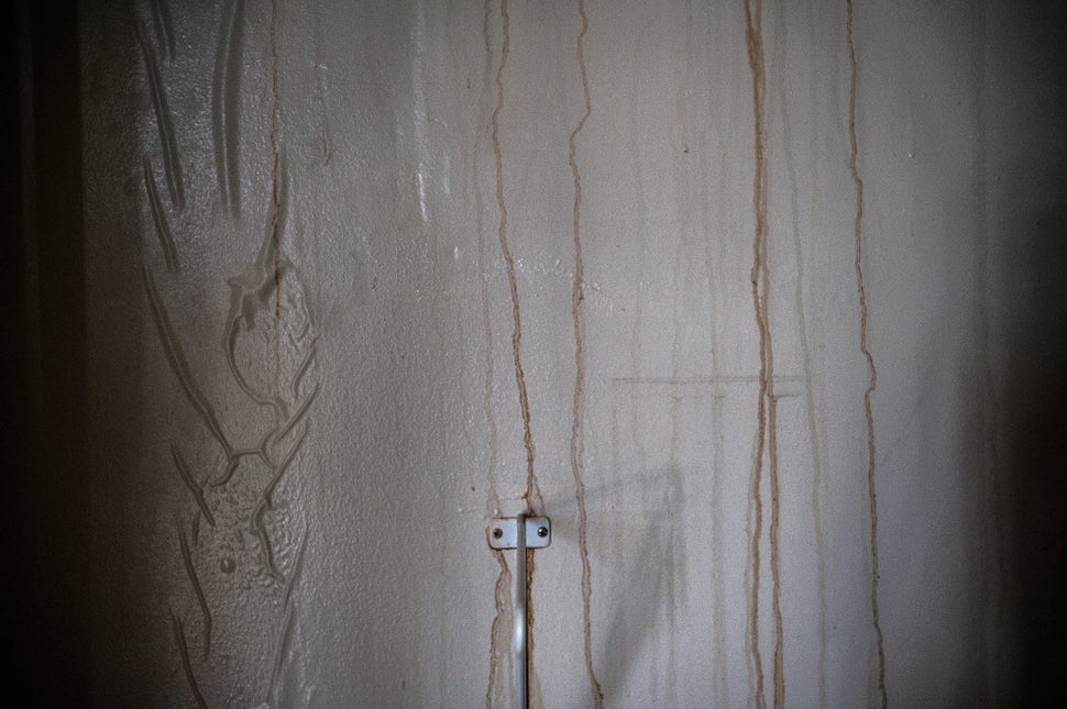 Water damage in Debbie Williams' top-floor apartment. She said rainwater poured through her ceilings.