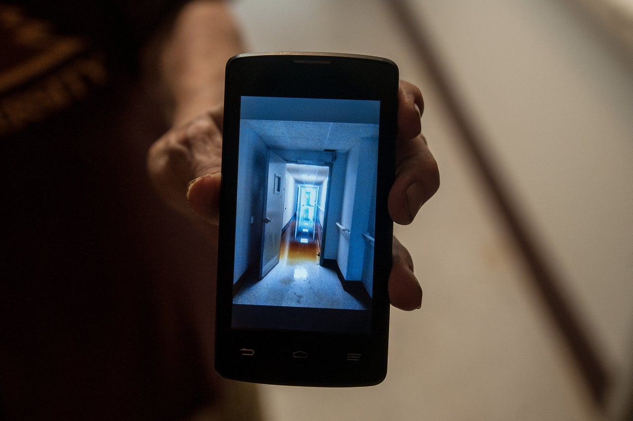 Dee Wyly shows photos she took of a flooded hallway in Solomon Towers during Hurricane Florence.