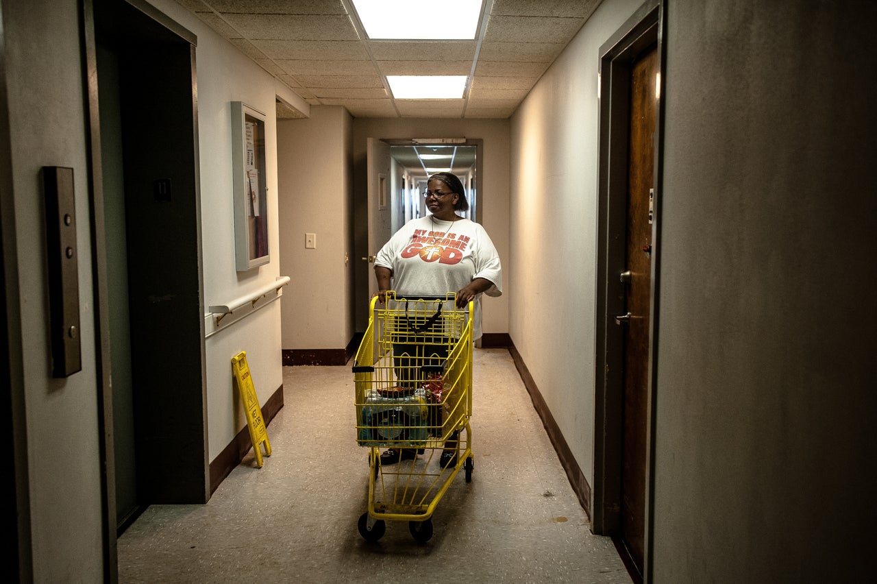 Debbie Williams takes food and water brought in by the Wilmington Police Department to her 11th-floor apartment.