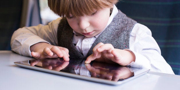 Boy enjoying technology on the the train