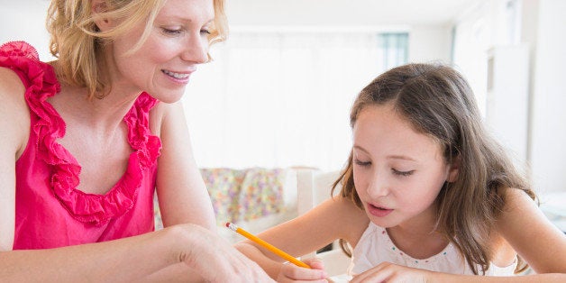 Mother and daughter (8-9 years) doing homework