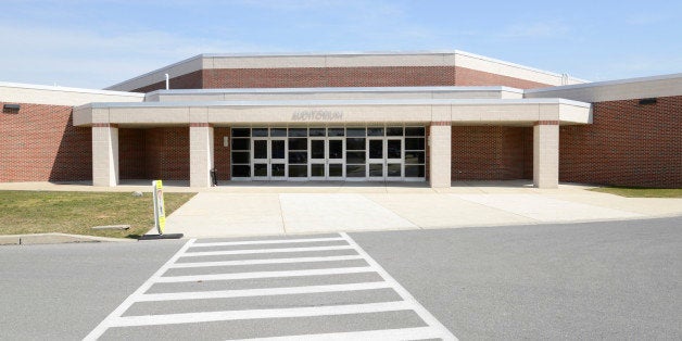 white painted crosswalks lines for safety by a modern school