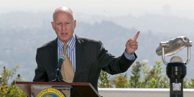 FILE - In this Oct. 7, 2015, file photo, California Gov. Jerry Brown speaks before signing a bill to combat climate change during a ceremony at Griffith Observatory in Los Angeles. California enacted some of the nation's most aggressive social polices this year, including SB350, which calls for increasing the state's renewable electricity use to 50 percent and doubling energy efficiency in existing buildings by 2030. (AP Photo/Damian Dovarganes, File)