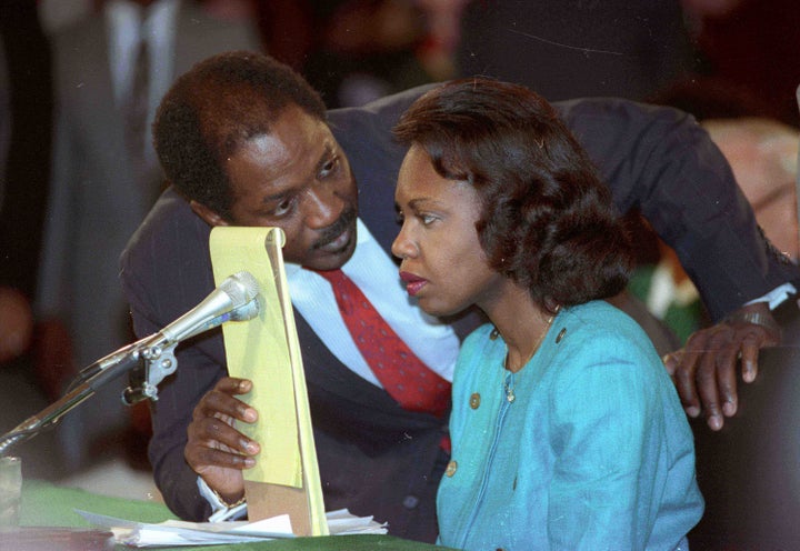 Counsel Charles Ogeltree uses a legal pad to cover a microphone as he advises law professor Anita Hill during her testimony Oct. 11, 1991 before the Senate Judiciary Committee hearings on Supreme Court nominee Judge Clarence Thomas.