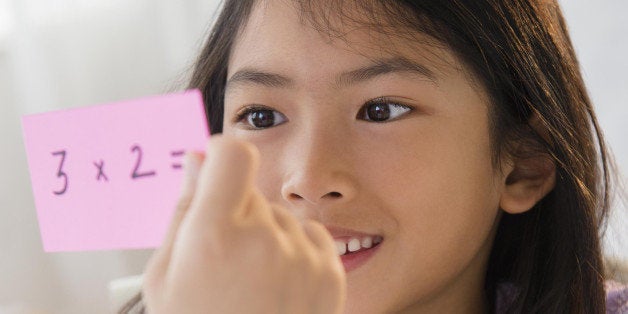 Vietnamese girl studying math with flash cards