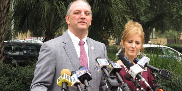 Democratic candidate for governor John Bel Edwards, with his wife Donna, speaks after Republican Lt. Gov. Jay Dardenne announ
