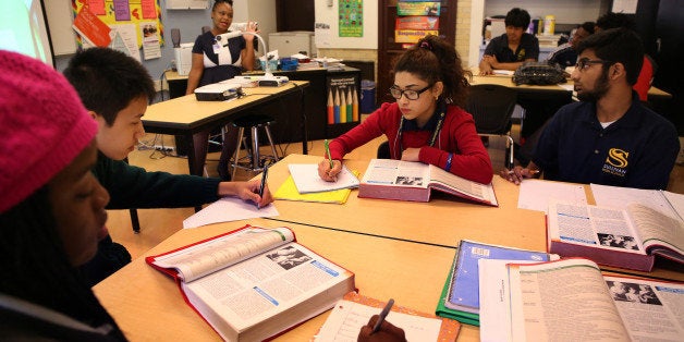 Students Muna Biswa, 17, middle and Zayyan Shaikh, 17, right, work during a health science class at Sullivan High School in C