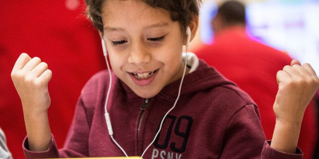 NEW YORK, NY - DECEMBER 09: Osiel Dominguez, a third grade student from PS 57 James Weldon Johnson Leadership Academy, learns how to code at an Apple Store through Apple's 'Hour of Code' workshop program on December 9, 2015 in New York City. Tim Cook, CEO of Apple, visited the students and said he hoped that teaching coding to children would become standard in education throughout the United States. (Photo by Andrew Burton/Getty Images)