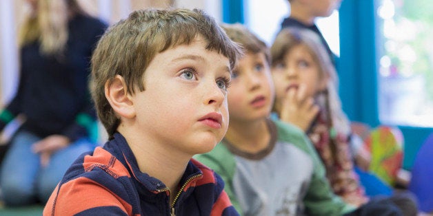 Children sitting and listening in classroom