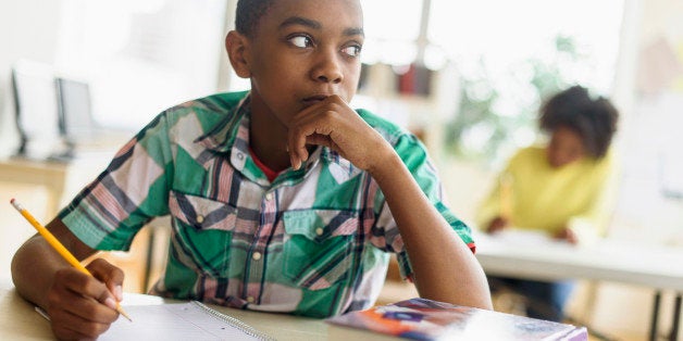 Black student thinking in classroom