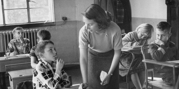 At the American school in the US Air Force base at Bushey Park, near Kingston-on-Thames, Surrey teacher Connie Colthurst from Virginia talks to young Jerry MacBoyle from Mississippi.