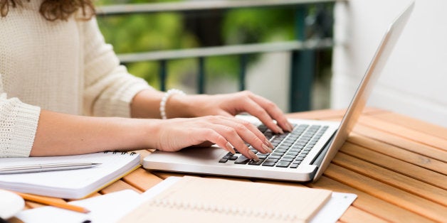 Side view of woman working on laptop, selective focus