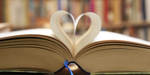 Book page in heart shape with library background