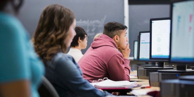 College students studying at computers in classroom
