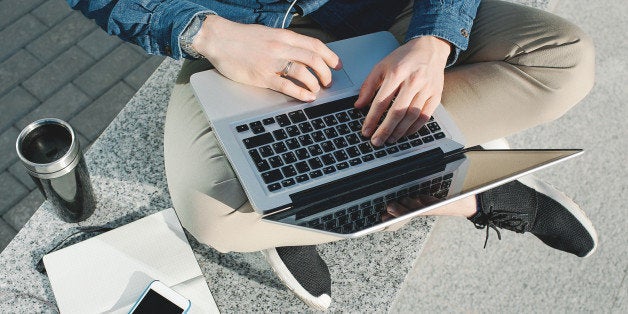 Smartphone, coffee tablet and laptop with notepad in hands of man outdoors in summer