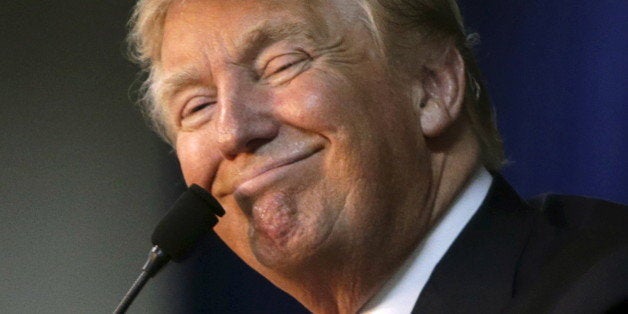 Republican presidential candidate Donald Trump smiles at his campaign rally in Manassas, Virginia December 2, 2015. Republican presidential front-runner Trump said on Wednesday his plan for combating Islamic State militants involves targeting not just the group's fighters but also their families. REUTERS/Gary Cameron 