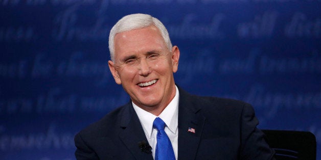 Republican U.S. vice presidential nominee Governor Mike Pence laughs as he discusses an issue with Democratic U.S. vice presidential nominee Senator Tim Kaine (off camera) during their vice presidential debate at Longwood University in Farmville, Virginia, U.S., October 4, 2016. REUTERS/Jonathan Ernst