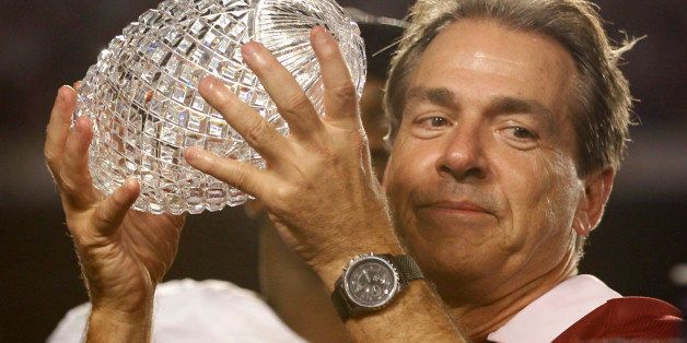 Alabama Crimson Tide's head coach Nick Saban holds up The Coaches Trophy after they defeated the Notre Dame Fighting Irish at their NCAA BCS National Championship college football game in Miami, Florida January 7, 2013. REUTERS/Jeff Haynes (UNITED STATES - Tags: SPORT FOOTBALL) 