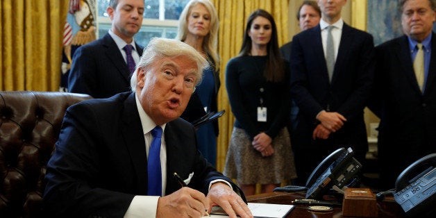 U.S. President Donald Trump looks up while signing an executive order to advance construction of the Keystone XL pipeline at
