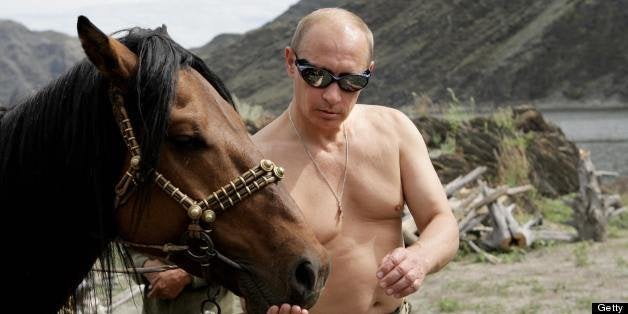 Russian Prime Minister Vladimir Putin is pictured with a horse during his vacation outside the town of Kyzyl in Southern Sibe