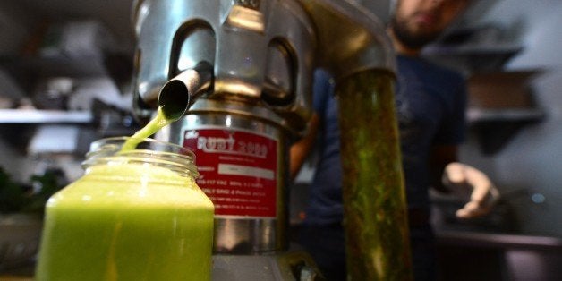 TO GO WITH AFP STORY by Leila Macor, Lifestyle-food-US-health-juice Alexander Mendez works the juicing machine at the Silver Lake Juice Bar on September 17, 2013 in the Silver Lake district of Los Angeles, California. In the past two to three years Juice Bars have been growing in popularity and juice cleansing has become a 5 billion dollar industry nationwide, appealing to those who want to lose weight and 'detox' their bodies. AFP PHOTO/Frederic J. BROWN (Photo credit should read FREDERIC J. BROWN/AFP/Getty Images)