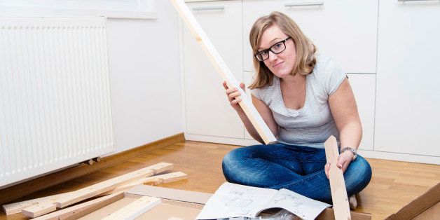 Furniture assembling. Woman trying to assemble table.