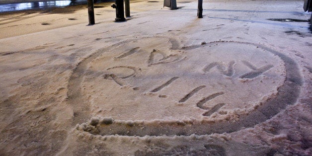 NEW YORK, NY - JANUARY 2: 'I love New York 2.1.14' is stenciled into the snow during winter storm 'Hercules' in lower Manhattan January 2, 2014 in New York City. The storm is expected to dump up to 10 inches of snow overnight. So far, there have been over 2,000 flight cancellations, and New York Governor Cuomo has shut down LIE service. (Photo by Allison Joyce/Getty Images)