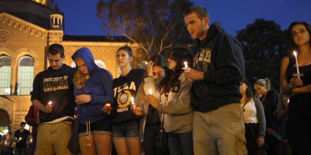 LOS ANGELES , CA - MAY 26: Students of UCSB and UCLA mourn at a candlelight vigil at UCLA for the victims of a killing rampage over the weekend near UCSB on May 26, 2014 in Los Angeles, California. According to reports, 22 year old Elliot Rodger, son of assistant director of the Hunger Games, Peter Rodger, began his mass killing near the University of California, Santa Barbara by stabbing three people to death in an apartment. He then went on to shooting and running down people while driving his BMW until crashing with a self-inflicted gunshot wound to the head. Officers found three legally-purchased guns registered to him inside the vehicle. Prior to the murders, Rodger posted YouTube videos declaring his intention to annihilate the girls who rejected him sexually and others in retaliation for his remaining a virgin at age 22. Seven people died, including Rodger, and seven others were wounded. (Photo by David McNew/Getty Images)