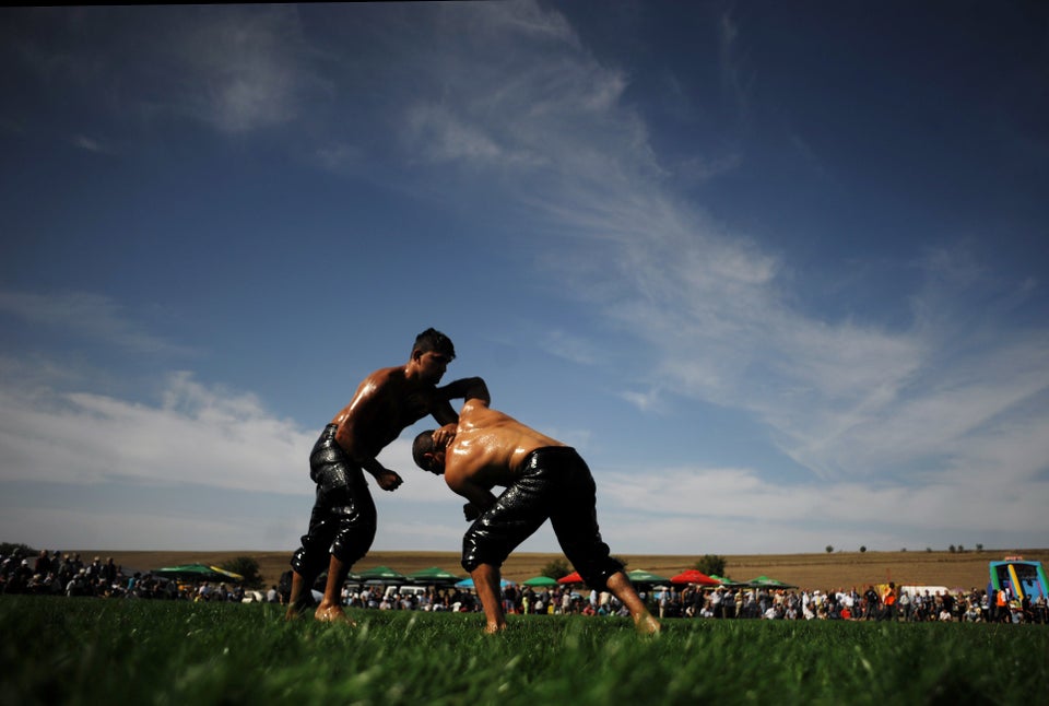 Bulgarian oil wrestlers, known as pehlivans, fight on September 30, 2012 during a traditional oil wrestling competition near 