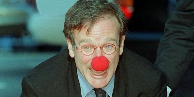 HOLLYWOOD, : Academy Award-winning actor Robin Williams wears a clown nose as he places his hands in cement during his hand