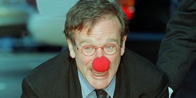 HOLLYWOOD, : Academy Award-winning actor Robin Williams wears a clown nose as he places his hands in cement during his hand and footprint ceremony outside Mann's Chinese Theatre 22 December in Hollywood, California. Williams is currently starring in the critically acclaimed film 'Patch Adams' about a doctor who uses humor to help heal his patients. AFP PHOTO/Vince BUCCI (Photo credit should read Vince Bucci/AFP/Getty Images)