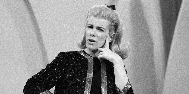 American comedienne Joan Rivers strikes a puzzled pose while performing her act on 'The Ed Sullivan Show,' New York, New York, December 12, 1966. (Photo by CBS Photo Archive/Getty Images)