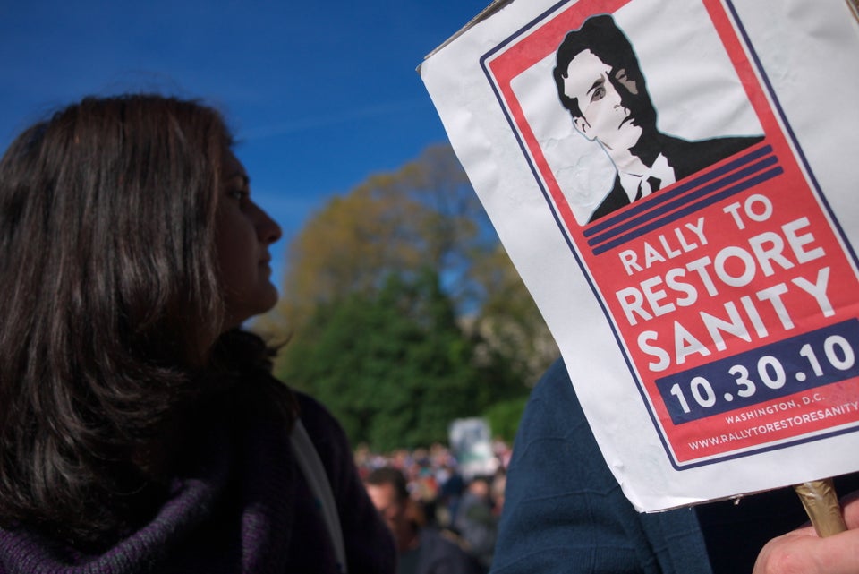 A woman stands next to a placard for Jon