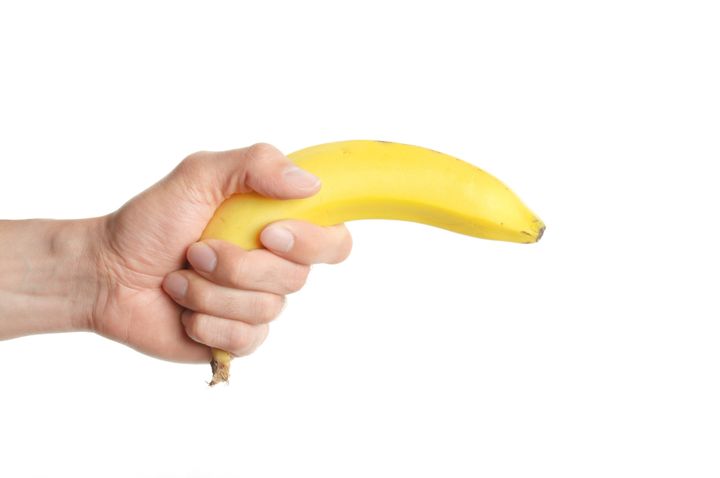 a man holding a banana isolated ...