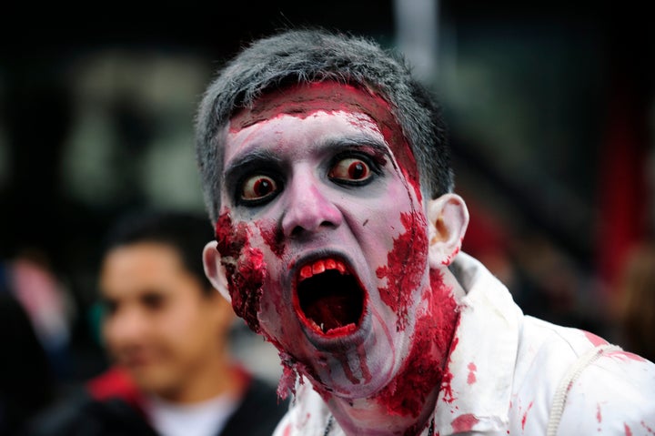 A man dressed up as a zombie takes part in a 'Zombie Walk' at the Revolution Monument in Mexico City on November 3, 2012. According to organizers, 15,000 people will take part in the event in an attempt to set a new Guinness record. AFP PHOTO/Alfredo Estrella (Photo credit should read ALFREDO ESTRELLA/AFP/Getty Images)