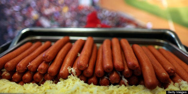 BOSTON - APRIL 5: Boston Mayor M. Thomas Menino, escorted by Red Sox president Larry Lucchino, during the annual pre-opening day tour at Fenway Park. Fenway Franks being served at the new Royal Rooters Club. (Photo by John Tlumacki/The Boston Globe via Getty Images)