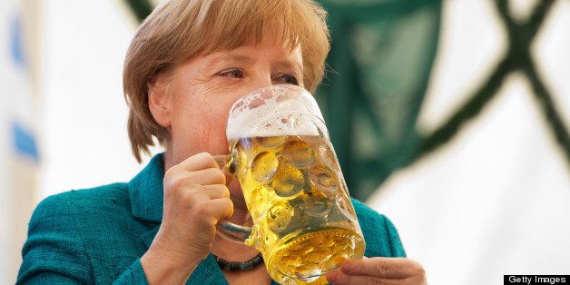 German Chancellor Angela Merkel drinks a glass of beer at a festival in Munich, southern Germany on May 15, 2013. AFP PHOTO / PETER KNEFFEL GERMANY OUT (Photo credit should read PETER KNEFFEL/AFP/Getty Images)
