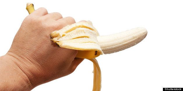 a banana in his hand on a white ...