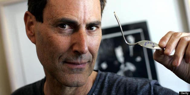 Tel Aviv, ISRAEL: Israeli magician Uri Geller holds a spoon he claims to have bent using supernatural powers during an interview with AFP in Tel Aviv, 17 January 2006. A war of magicians is raging in Israel pitting Geller, with his aura of supernatural powers, against those who see in him nothing but an inexhaustable lust for fame. AFP PHOTO/DAVID FURST (Photo credit should read DAVID FURST/AFP/Getty Images)